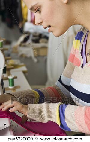 Seamstress sewing on sewing machine View Large Photo Image Stock Photo - Seamstress sewing on sewing machine. Fotosearch