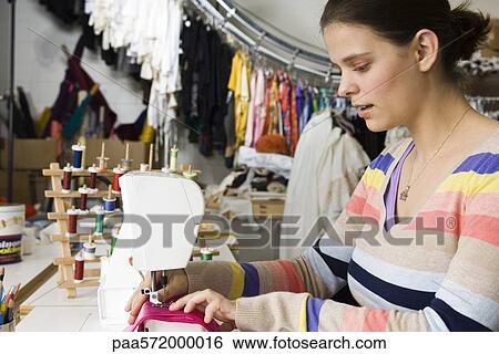 Seamstress sewing on sewing machine View Large Photo Image Stock Photograph - Seamstress sewing on sewing machine. Fotosearch