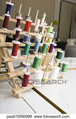 Spools of thread on rack View Large Photo Image Stock Photograph - Spools of thread on rack. Fotosearch