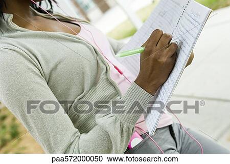 Student writing in notebook, cropped View Large Photo Image Stock Image - Student writing in notebook, cropped. Fotosearch