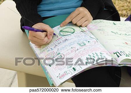 Student writing in notebook illustrated with doodles View Large Photo Image Stock Image - Student writing in notebook illustrated with doodles. Fotosearch