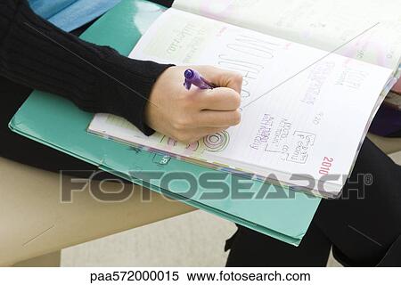 Student writing in notebook View Large Photo Image Stock Photography - Student writing in notebook. Fotosearch