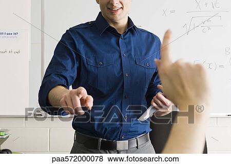 Teacher answering student's question View Large Photo Image Stock Photo - Teacher answering student's question. Fotosearch