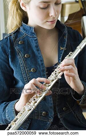 Young woman holding flute View Large Photo Image Stock Photo - Young woman holding flute. Fotosearch