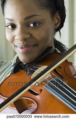 Young woman playing violin, portrait View Large Photo Image Stock Image - Young woman playing violin, portrait. Fotosearch