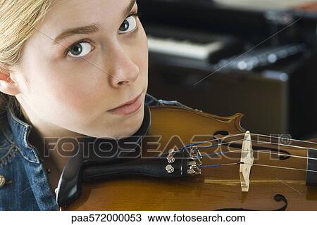 Young woman playing violin, portrait View Large Photo Image Stock Image - Young woman playing violin, portrait. Fotosearch