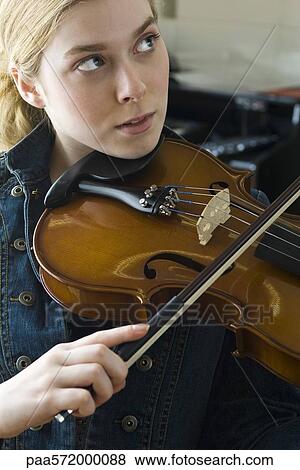 Young woman practicing violin View Large Photo Image Stock Photo - Young woman practicing violin. Fotosearch