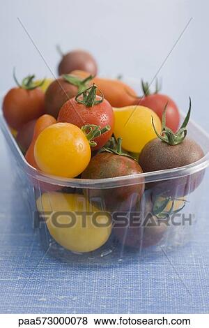 Assorted cherry and plum tomatoes in plastic container View Large Photo Image Stock Photo - Assorted cherry and plum tomatoes in plastic container. Fotosearch