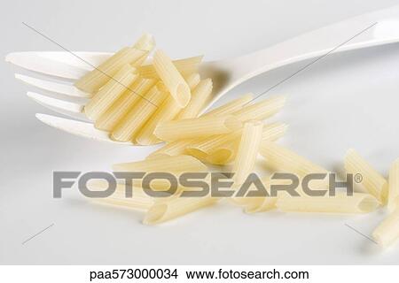 Gluten-free penne pasta made from rice View Large Photo Image Picture - Gluten-free penne pasta made from rice. Fotosearch