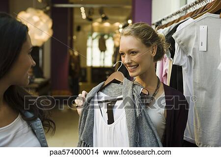 Friends shopping in clothing boutique View Large Photo Image Picture - Friends shopping in clothing boutique. Fotosearch