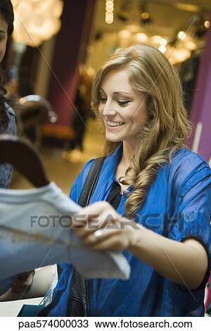 Friends shopping in clothing boutique View Large Photo Image Stock Image - Friends shopping in clothing boutique. Fotosearch