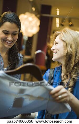 Friends shopping in clothing boutique View Large Photo Image Stock Photograph - Friends shopping in clothing boutique. Fotosearch