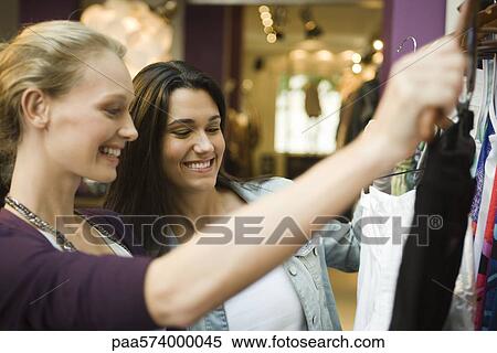 Friends shopping in clothing boutique View Large Photo Image Stock Photography - Friends shopping in clothing boutique. Fotosearch