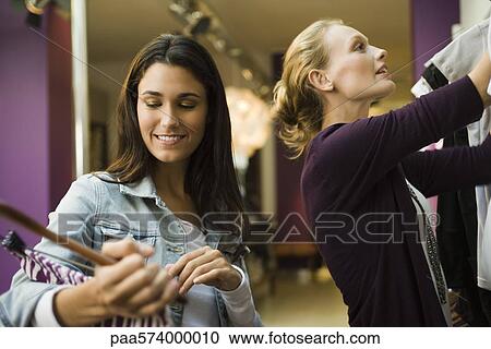 Friends shopping in clothing store View Large Photo Image Stock Image - Friends shopping in clothing store. Fotosearch