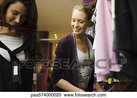 Friends shopping in clothing store View Large Photo Image Stock Image - Friends shopping in clothing store. Fotosearch