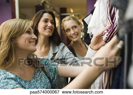 Friends shopping in clothing store View Large Photo Image Stock Photo - Friends shopping in clothing store. Fotosearch