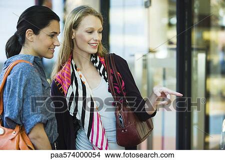 Friends window shopping View Large Photo Image Picture - Friends window shopping. Fotosearch