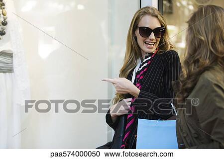 Friends window shopping View Large Photo Image Stock Image - Friends window shopping. Fotosearch