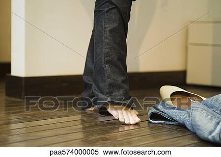 Stock Photography - Putting on jeans. Fotosearch