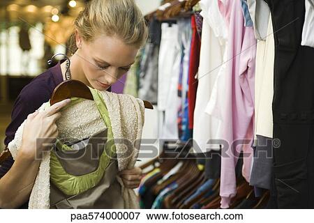 Stock Photo - Shopping in clothing store. Fotosearch