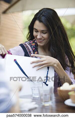 Woman looking in shopping bag View Large Photo Image Stock Photo - Woman looking in shopping bag. Fotosearch