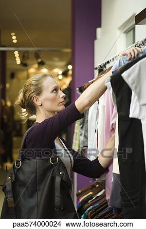 Woman shopping in boutique View Large Photo Image Picture - Woman shopping in boutique. Fotosearch