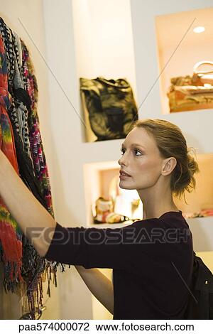 Woman shopping in boutique View Large Photo Image Stock Image - Woman shopping in boutique. Fotosearch
