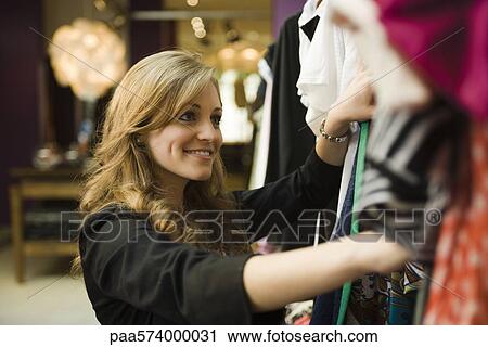 Woman shopping in clothing boutique View Large Photo Image Stock Image - Woman shopping in clothing boutique. Fotosearch