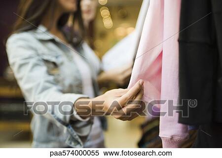 Woman shopping in clothing store View Large Photo Image Stock Photography - Woman shopping in clothing store. Fotosearch