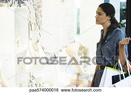 Stock Photograph - Woman window shopping. Fotosearch