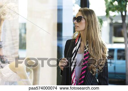 Young woman window shopping View Large Photo Image Picture - Young woman window shopping. Fotosearch