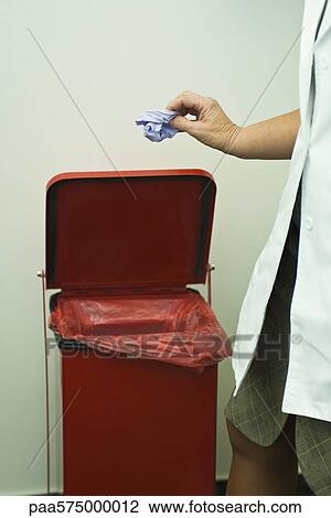 Discarding disposable latex glove in medical waste bin View Large Photo Image Stock Image - Discarding disposable latex glove in medical waste bin. Fotosearch