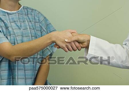 Doctor and patient shaking hands View Large Photo Image Stock Photo - Doctor and patient shaking hands. Fotosearch