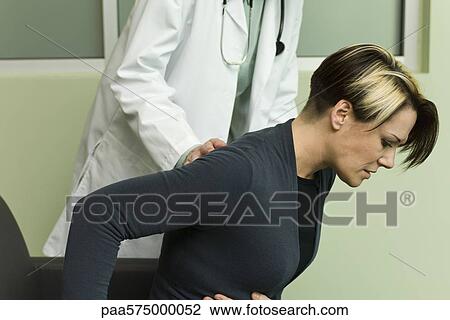 Doctor assisting patient experiencing severe abdominal pain View Large Photo Image Stock Image - Doctor assisting patient experiencing severe abdominal pain. Fotosearch