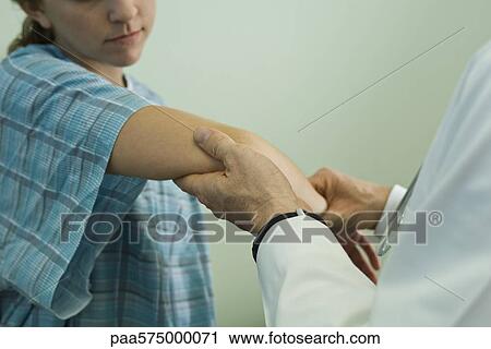Doctor examining patient's arm View Large Photo Image Stock Image - Doctor examining patient's arm. Fotosearch