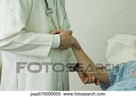 Doctor examining patient's arm View Large Photo Image Stock Photography - Doctor examining patient's arm. Fotosearch