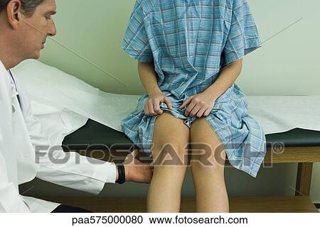 Doctor examining patient's leg and knee View Large Photo Image Stock Image - Doctor examining patient's leg and knee. Fotosearch