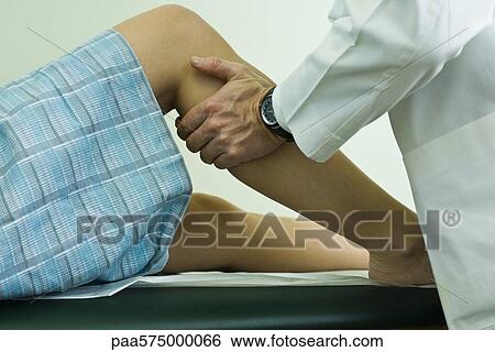 Doctor examining patient's leg and knee View Large Photo Image Stock Photograph - Doctor examining patient's leg and knee. Fotosearch