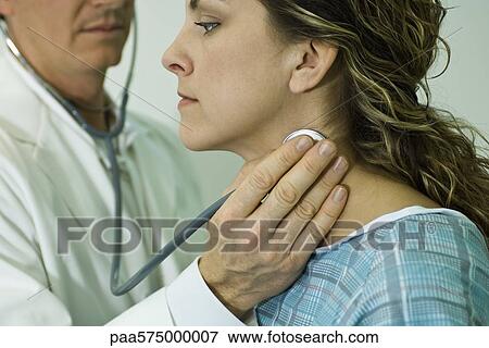 Doctor listening to patient's pulse with stethoscope View Large Photo Image Stock Photo - Doctor listening to patient's pulse with stethoscope. Fotosearch