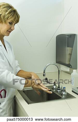 Stock Image - Doctor washing hands. Fotosearch