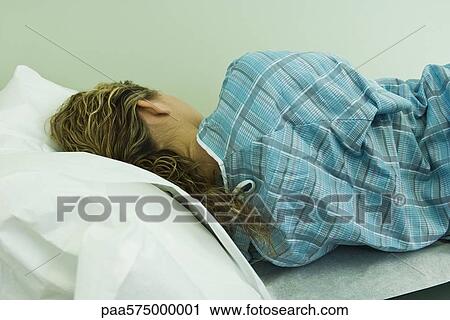 Female patient lying on side on examination table View Large Photo Image Stock Image - Female patient lying on side on examination table. Fotosearch