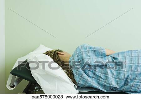 Female patient lying on side on examination table View Large Photo Image Stock Photo - Female patient lying on side on examination table. Fotosearch