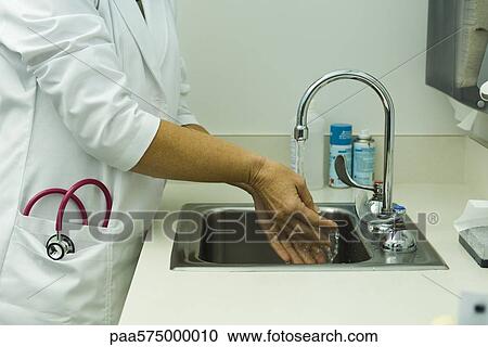 Healthcare worker washing hands in doctor's office View Large Photo Image Stock Image - Healthcare worker washing hands in doctor's office. Fotosearch
