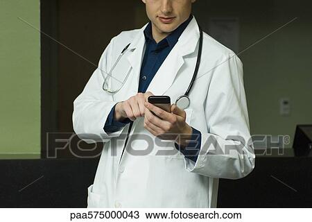 Male doctor text messaging View Large Photo Image Stock Image - Male doctor text messaging. Fotosearch