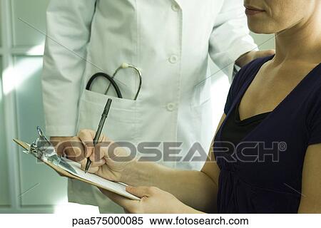 Patient completing medical paperwork View Large Photo Image Stock Photography - Patient completing medical paperwork. Fotosearch