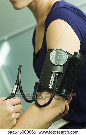Patient having blood pressure checked View Large Photo Image Stock Photography - Patient having blood pressure checked. Fotosearch