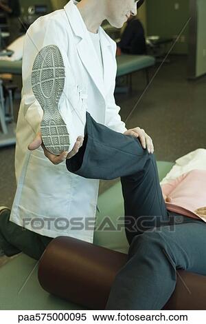 Stock Photography - Patient receiving physical therapy treatment. Fotosearch