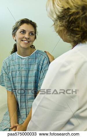 Patient smiling with relief while receiving good news from doctor View Large Photo Image Stock Image - Patient smiling with relief while receiving good news from doctor. Fotosearch