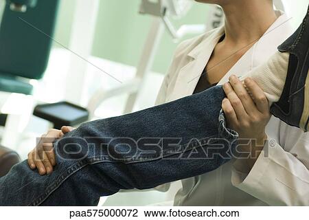 Stock Image - Physical therapist treating patient. Fotosearch