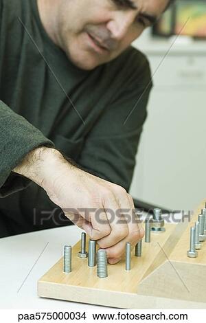 Using therapeutic tool for improving fine motor and sensory function View Large Photo Image Picture - Using therapeutic tool for improving fine motor and sensory function. Fotosearch